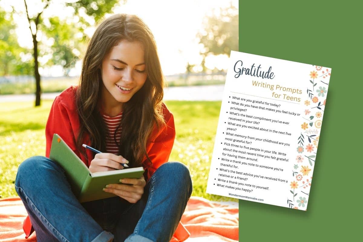 Young woman writing in a journal while sitting on a blanket in a park with a list of 'gratitude writing prompts for teens' next to her.