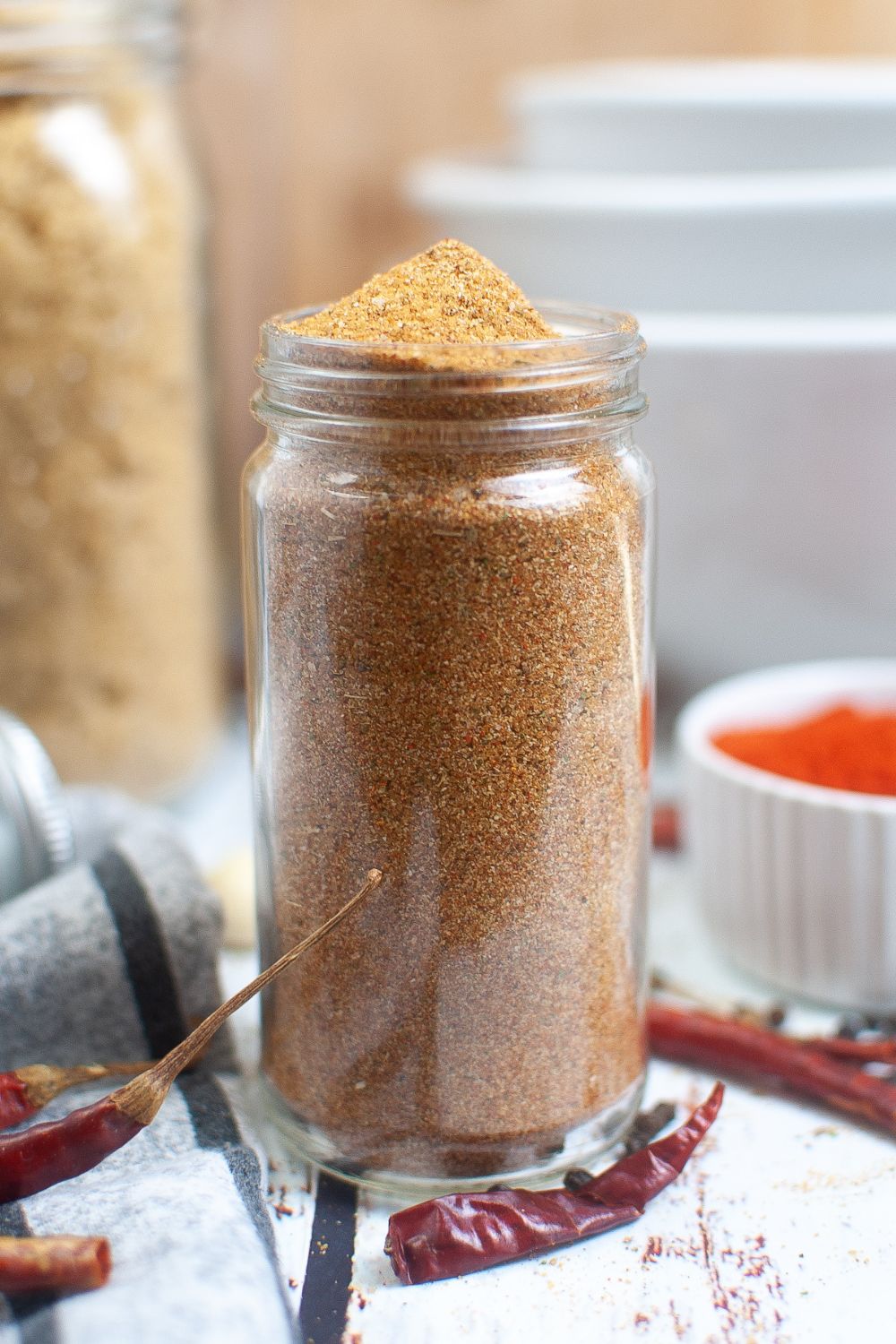 Chile powder in a jar on a table, perfect for dry rub.