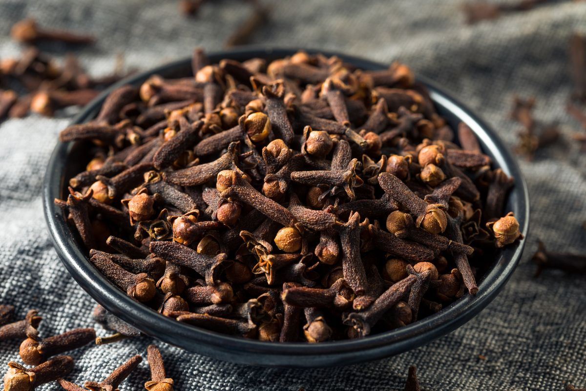 Cloves, a substitute for Caraway Seeds, in a bowl on a cloth.