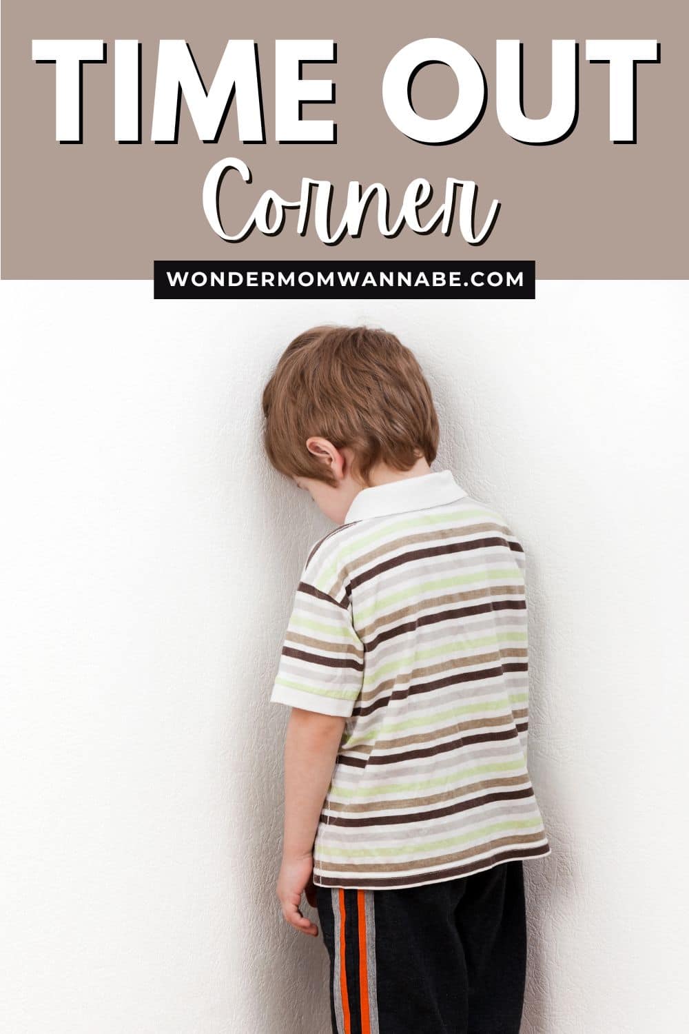 A young child standing facing a wall in a designated 'time out corner'.
